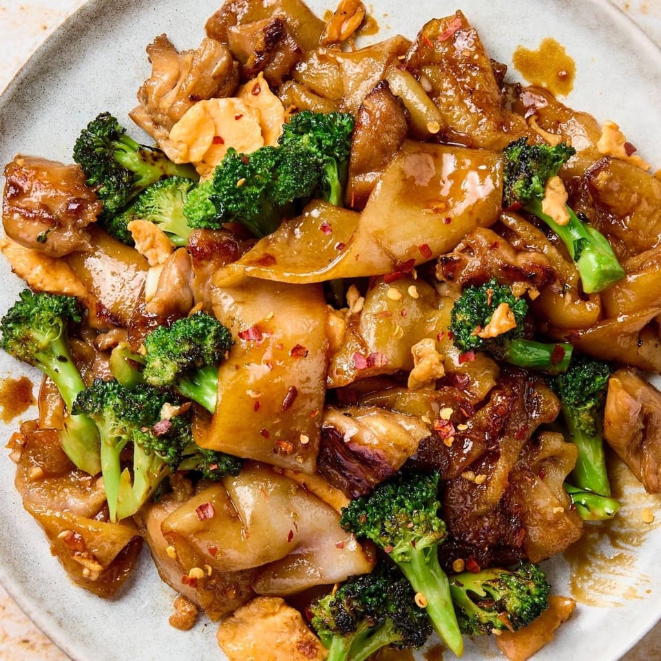 Close-up of Pho-Chau's Vietnamese stir-fried noodles with chicken, broccoli, and chili flakes.